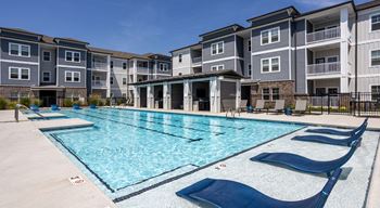 Sparkling saltwater swimming pool with in-pool tanning ledges, fountain sprays and three designated swimming lanes